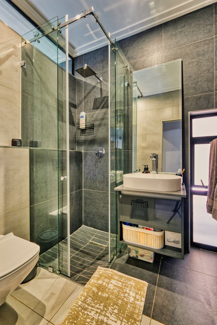 services-10 Stylish bathroom interior with glass shower, contemporary sink, and sleek design elements.