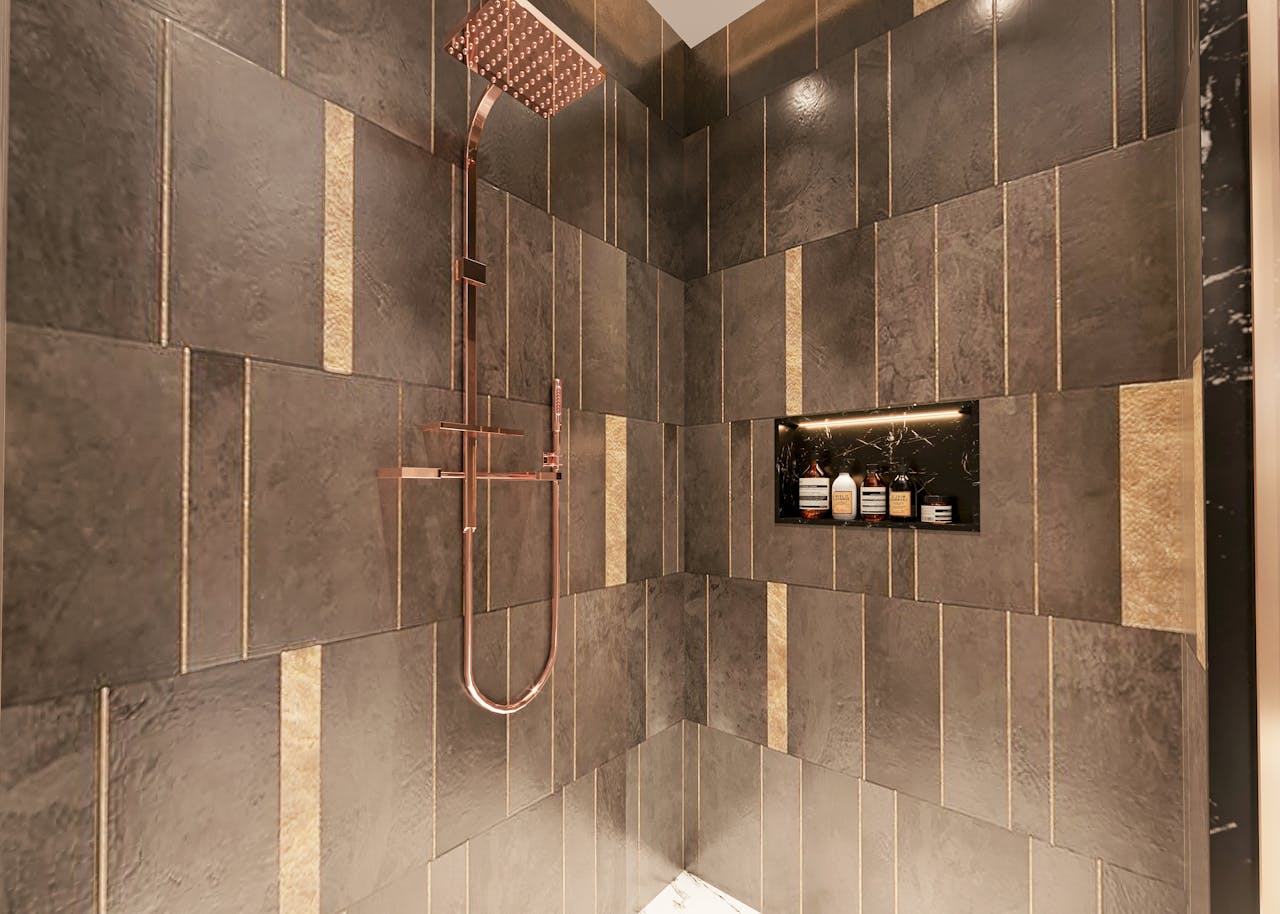 Luxurious modern shower with dark textured tiles and copper fixtures for a sophisticated bathroom design.